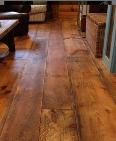 wood flooring in a living room with couches