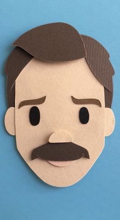 a paper cut out of a man with a mustache