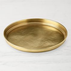 a gold plate sitting on top of a white table