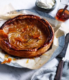 an onion dish on a plate next to some sauces