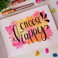 the words choose to be happy written on a piece of paper next to markers and pencils