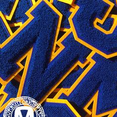 blue and yellow letters with the letter m on them