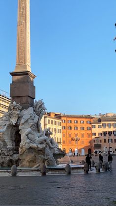 people are walking around in front of a monument