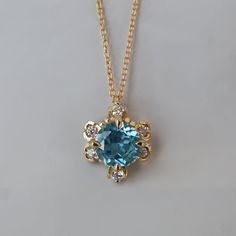 Weave a dreamy look around your neck with this London Blue Topaz Reverie Necklace. A single gem encrusted with sparkly CZ hangs delicately on a gold-filled chain. Adorned with milgrain details and a dark saturated natural london blue topaz. Wear this necklace to bring a touch of elegant enchantment to your look. Available in gold vermeil and 14K solid gold. Model is wearing a 16" gold filled chain necklace. Gold vermeil or 14k solid gold 7mm natural london blue topaz Cubic zirconia 16" or 18" go Formal Blue Necklace With Rose Cut Diamonds, Blue Pendant Necklaces With Rose Cut Diamonds, Blue Rose Cut Diamond Pendant Necklace, Elegant Blue Necklaces With Rose Cut Diamonds, Exquisite Blue Topaz Necklace Gift, Exquisite Blue Topaz Necklace For Gift, Blue Rose Cut Diamond Necklaces For Weddings, Blue Rose Cut Diamond Necklace For Weddings, Blue Rose Cut Diamond Wedding Necklace