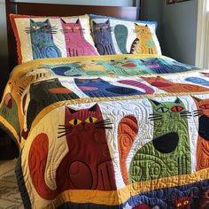 a quilted bed with many cats on it