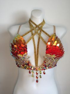 a white mannequin with red and gold jewelry on it's back neck