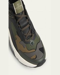 Valentino Garavani "True Act" runner sneakers in camo printed mesh and leather    Flat heel    Reinforced round toe    Laceup vamp with label    Pull tab on the backstay    Padded collar    Heel with rubber Rockstuds and leather logo    Branded midsole    Rubber outsole    Lining: Elastane/nylon    Made in Italy Sporty Camouflage Sneakers For Sports, Low-top Camouflage Sneakers For Outdoor, Camouflage Low-top Sneakers For Outdoor, Outdoor Camouflage Low-top Sneakers, Camouflage Sneakers For Outdoor Sports, Sporty Camouflage Sneakers For Outdoor, Luxury Leather Outdoor Sneakers, Camouflage Round Toe Sneakers For Sports, Camouflage Sneakers With Round Toe For Sports