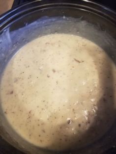 a bowl filled with soup sitting on top of a stove