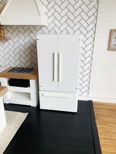 a white refrigerator freezer sitting next to a stove top oven