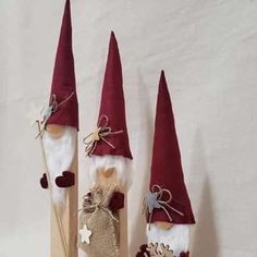 three red and white gnome's hats on wooden sticks