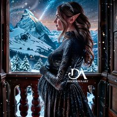 a woman standing in front of a window looking out at the snow covered mountains and stars