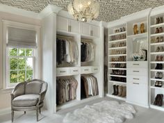 a walk in closet filled with lots of white furniture and shoes on top of shelves