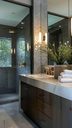 a bathroom with marble counter tops and large mirrors