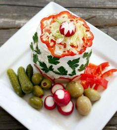 a white plate topped with assorted vegetables and veggies on top of it