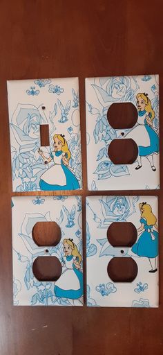 three light switch covers with cartoon characters on them