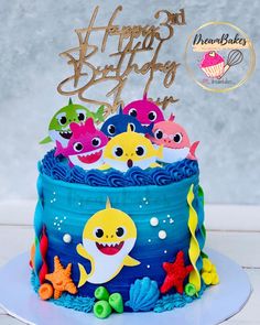 a birthday cake decorated with colorful fish and under the sea theme