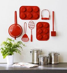 a kitchen counter with pots, pans and utensils hanging on the wall