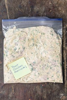 a piece of bread that is in a plastic bag on a wooden table with a note attached to it