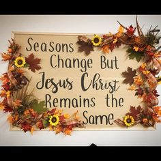 a sign that says, seasons change but jesus christ remains the same place with sunflowers and fall leaves