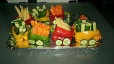 a tray filled with cut up veggies on top of a metal countertop