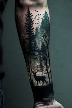 a man's arm with a deer in the woods and birds flying over it