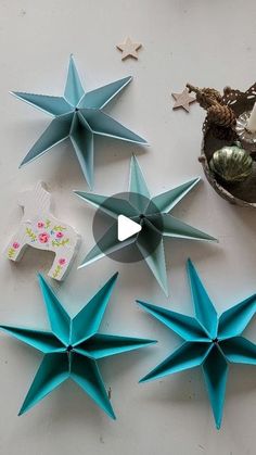 several blue paper stars sitting on top of a table