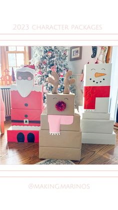 three cardboard boxes with santa claus and reindeer on them in front of a christmas tree