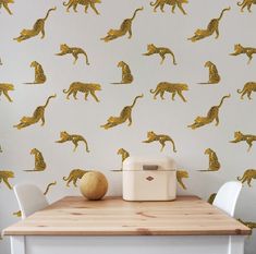 the wallpaper is decorated with gold cheetah and leopards on white walls