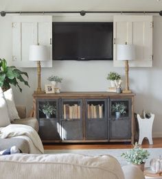 a living room with a tv mounted on the wall