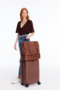 Introducing the mini edition of our OG weekender. This bag is a minimalist’s dream and is perfect as a personal item (+ just as good for an overnight trip, or even a weekend away). Take the stress out of packing with a wide, easy-access opening, a built-in padded laptop sleeve, and a separate bottom compartment (perfect for shoes, toiletries, or dirty laundry). Ready to go? Simply slide our trolley passthrough pocket over your suitcase handles, and you’re off! Versatile Travel Bag For Overnight Trips, Versatile Laptop Bag With Luggage Sleeve For Travel, Versatile Rectangular Weekender Bag For Overnight Trips, Versatile Brown Travel Bag For Weekend Trips, Versatile Tote Luggage For Overnight Trips, Brown Travel Bag For Overnight Trips, Modern Weekender Bag For Weekend Trips, Versatile Tote Luggage For Trip, Functional Brown Weekender Bag For Trips