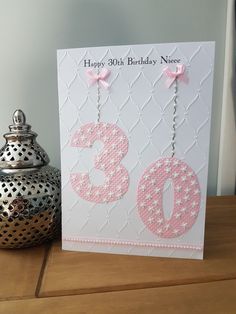 a happy 30th birthday card next to a teapot