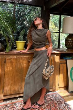 It's easy to say we’re obsessed with the Mila Olive Set, the newest color way of the Mila Set. This olive beauty features a slightly asymmetrical hemline and maxi silhouette, making it a must-have addition to your wardrobe. This top pairs perfectly with the Mila Olive Maxi Skirt and an olive martini in hand. Trust us, you’re going to need both colors—the olive and the leopard—to keep your style game strong all season long. Olive Martini, Fall Bottoms, Party Bottoms, Concert Dresses, Dresses Date Night, Bridal Tops, Beauty Features, Fall Wedding Guest Dress, Open Back Top