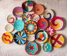 many colorful baskets are arranged on a white tablecloth and one has a star in the middle