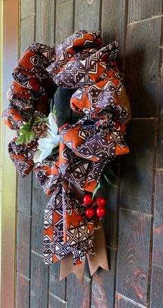 a wreath hanging on the side of a wooden door