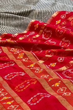 This exquisite pochampally ikkat silk saree is grey color is handwoven. The body is adorned with leheriya pattern while the elaborate broad border on one side is in maroon color with woven paisley motifs while the other side is plain along with gold zari lines. The maroon colored pallu repeats the paisley motifs along with gold zari lines. The blouse is in maroon color with lehriya pattern and decorated border in traditional ikkat designs. Approximate Length 6.5 mtrs (inclusive of blouse length) Transitional Art Silk Saree With Ikat Print, Festive Tussar Silk Dupatta With Ikat Print, Navratri Ikat Print Pre-draped Saree, Fusion Style Traditional Drape Dupatta For Navratri, Transitional Ikat Print Art Silk Saree, Festive Art Silk Dupatta With Ikat Print, Festive Banarasi Silk Traditional Wear With Ikat Print, Festive Ikat Print Art Silk Dupatta, Transitional Season Tussar Silk Saree With Ikat Print