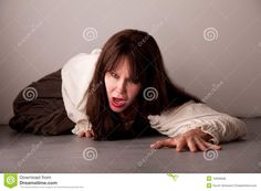 a woman is laying on the floor with her mouth open