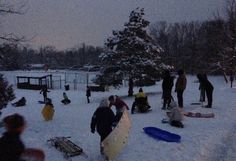 a group of people standing around in the snow