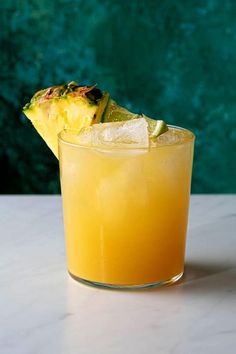 a pineapple drink in a glass on a table