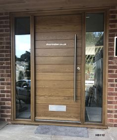 a modern wooden door with glass panels on the front and side doors to both sides