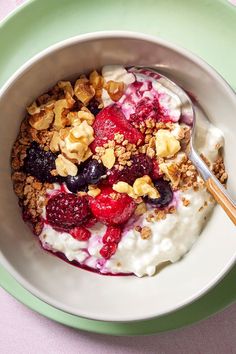 a bowl filled with yogurt, granola and fruit