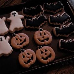 decorated cookies in the shape of ghost and pumpkins