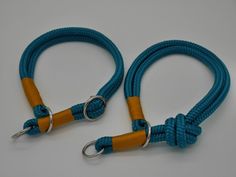 two blue and orange leashes with metal hooks