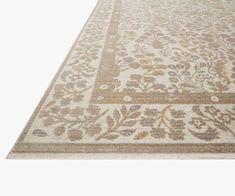 a beige rug with floral designs on it