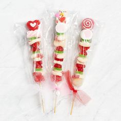 three candy lollipops wrapped in cellophane