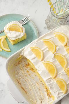 there is a cake with lemons on it and a fork next to the cake