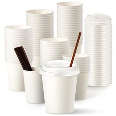 several white cups with brown straws in them