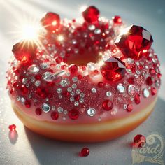 a donut covered in red and white sprinkles on top of a table