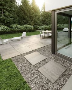 an outdoor patio area with grass and gravel