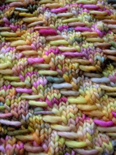 a close up view of colorful knitted material that looks like something out of yarn