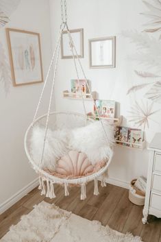 a white hanging chair in the corner of a room